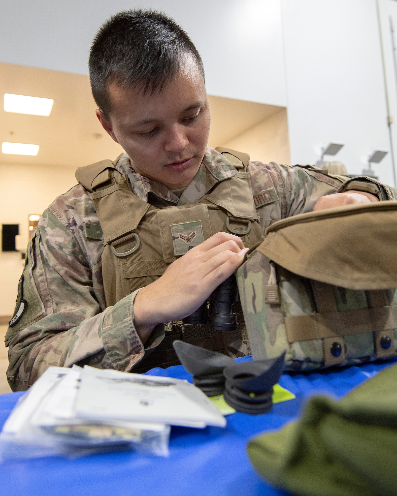U.S. Air Force Airman 1st Class Tai Tjing Quiton, 321st Contingency Response Squadron fire team member, checks his gear during deployment processing Sept. 14, 2019, at Travis Air Force Base, California. Contingency response forces from the U.S. and Royal Australian Air Forces staged at Travis AFB before deploying in support of exercise Mobility Guardian 2019. MG19 is Air Mobility Command’s flagship exercise for large-scale rapid global mobility operations. Forty-six U.S. aircraft will join aircraft from 29 international partners, along with more than 4,000 U.S. and international Air Force, Army, Navy and Marine Corps aviators. (U.S. Air Force photo by Louis Briscese)