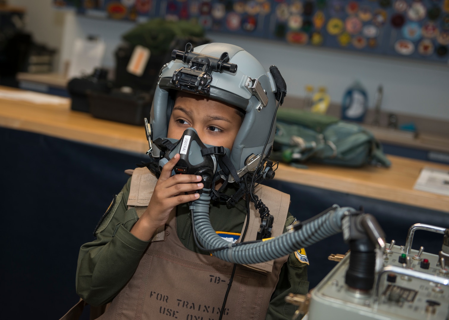 Jadiel Aponte, 103rd Airlift Wing honorary Pilot for a Day, breathes through an oxygen mask at the 103rd Operations Group aircrew flight equipment section during the 103rd Airlift Wing’s annual Pilot for a Day event at Bradley Air National Guard Base, East Granby, Conn. Sept. 19, 2019. The program puts the wing in partnership with local hospitals to identify a child with a life-threatening or terminal illness and bring them on base to meet members of the wing and learn about its mission. (U.S. Air National Guard photo by Staff Sgt. Steven Tucker)