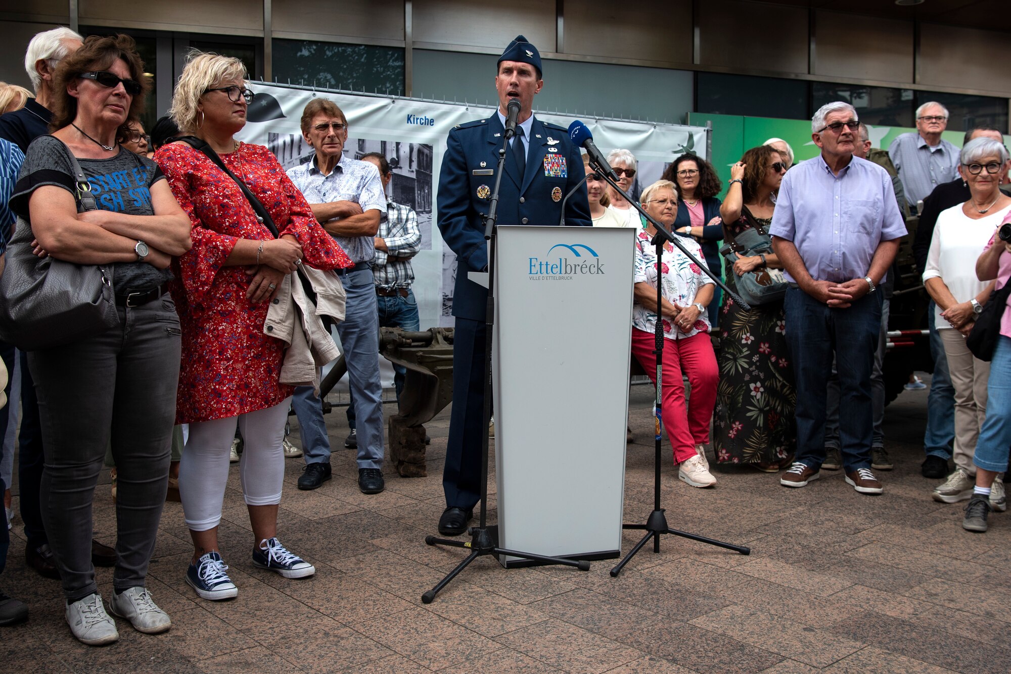 U.S. Air Force Col. David Epperson, 52nd Fighter Wing commander, center, speaks during a ceremony in celebration of the 75th anniversary of the liberation of Ettelbruck, Luxembourg, in Ettelbruck, Sept. 22, 2019. Local citizens gathered to listen to local leadership and Spangdahlem Air Base, Germany, leadership speak on the importance of Luxembourg's liberation in 1944. Participation in local events helps the U.S. military build partnership with the local community. (U.S. Air Force photo by Airman 1st Class Valerie Seelye)