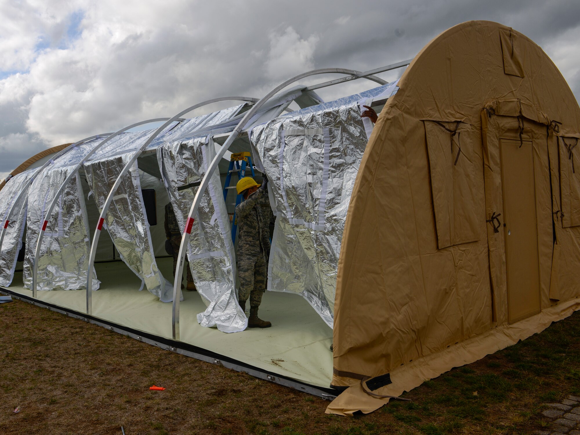 Airmen assigned to the 786th Civil Engineer Squadron build tents as part of Operation Varsity 19-3 at Ramstein Air Base, Germany, Sept. 23, 2019. Operation Varsity 19-3 is a weeklong exercise designed to test the capabilities of Airmen assigned to Ramstein Air Base. (U.S. Air Force photo by Tech. Sgt. Timothy Moore)