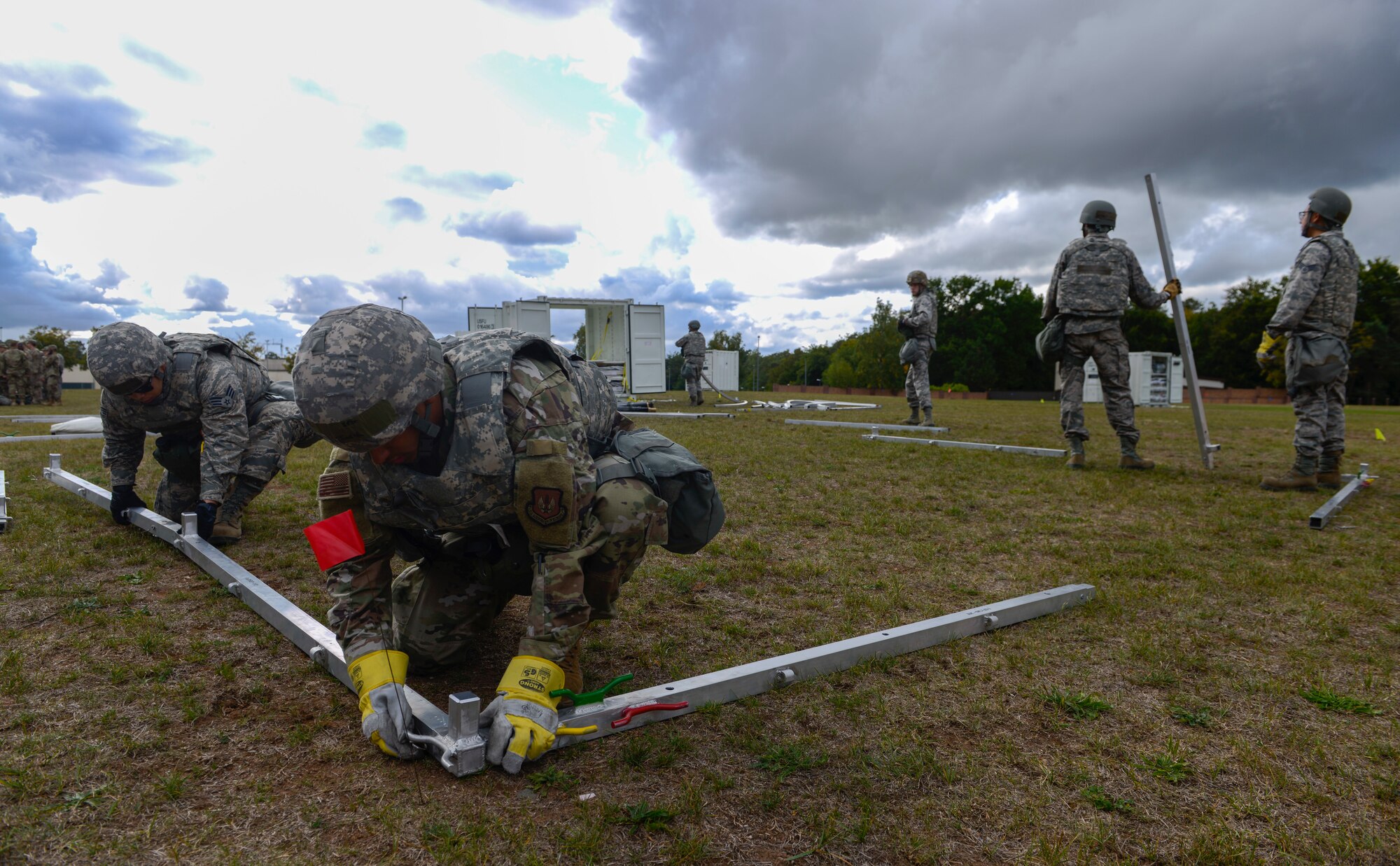 U.S. Airmen assigned to the 786th Civil Engineer Squadron build tents as part of Operation Varsity 19-3 at Ramstein Air Base, Germany, Sept. 23, 2019. The tents were used as temporary lodging for simulated deployers during Operation Varsity 19-3, a weeklong exercise designed to test the capabilities of Ramstein Airmen. (U.S. Air Force photo by Tech. Sgt. Timothy Moore)