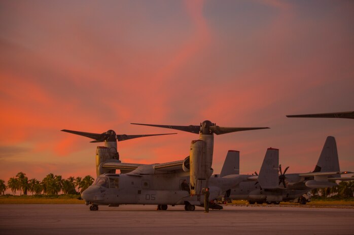 MV-22 Ospreys and KC-130J Hercules are parked during Marine Rotational Force - Darwin trans-Pacific flight, Cassidy International Airport, Kiribati, Sep. 19, 2019. The flight was conducted to improve upon the Osprey trans-Pacific concept that has been developed and refined over the past three MRF-D iterations.