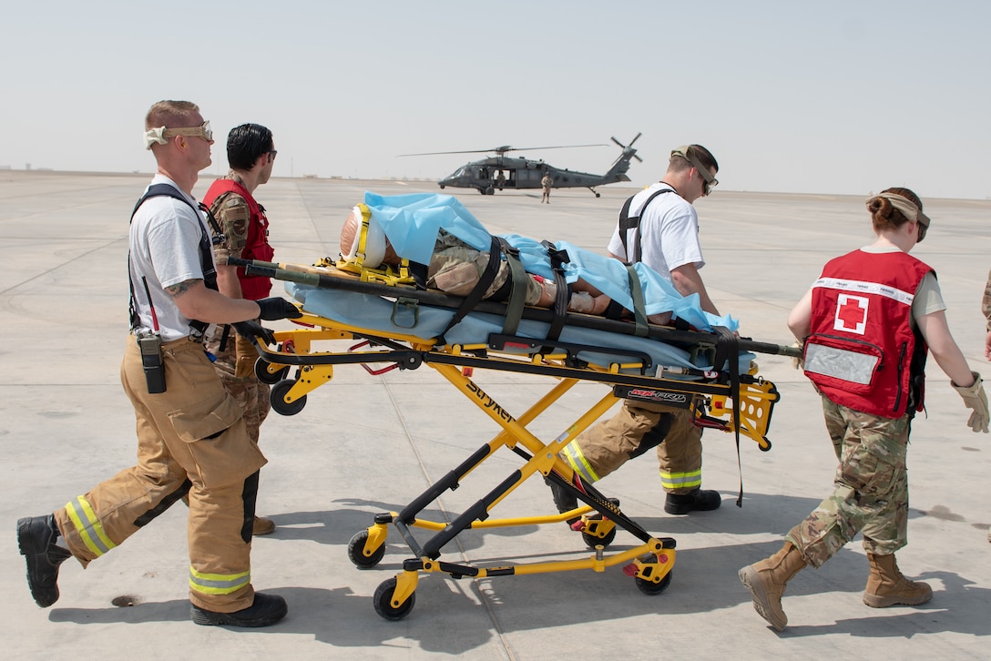 380th Air Expeditionary Wing firefighters and medics move a simulated patient to an Emirati UH-60 Black Hawk during a large first responder exercise Sept. 24, 2019, at Al Dhafra Air Base, United Arab Emirates. The exercise helped foster partnership with the United Arab Emirates Air Force Joint Aviation Command to practice an aeromedical evacuation scenario via helicopter. (U.S. Air Force photo by Staff Sgt. Chris Thornbury)