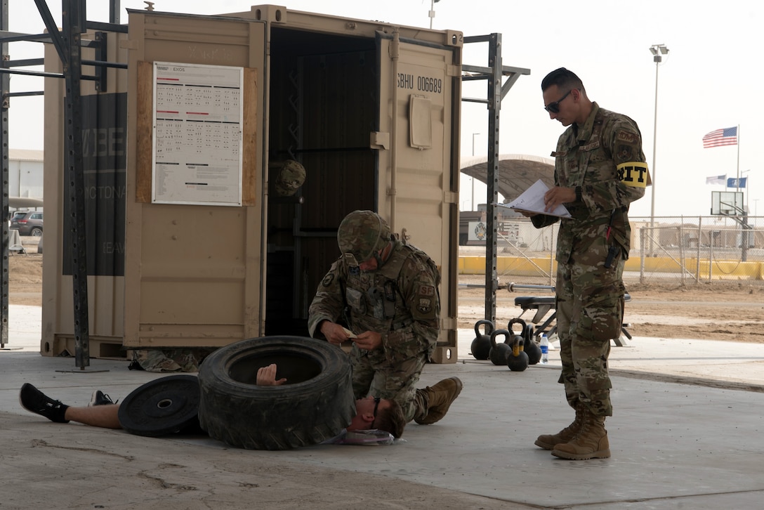 Tech. Sgt. James Sympson, 380th Expeditionary Security Forces Squadron patrolman, reads an exercise inject card while observed by a member of the wing inspection team on Al Dhafra Air Base, United Arab Emirates, Sept. 24, 2019. A variety of agencies including medics, firefighters and security forces defenders participated in the exercise to test their readiness, knowledge of emergency procedures and interagency cooperation amongst the wing’s first responders. (U.S. Air Force photo by Tech. Sgt. Jocelyn A. Ford)