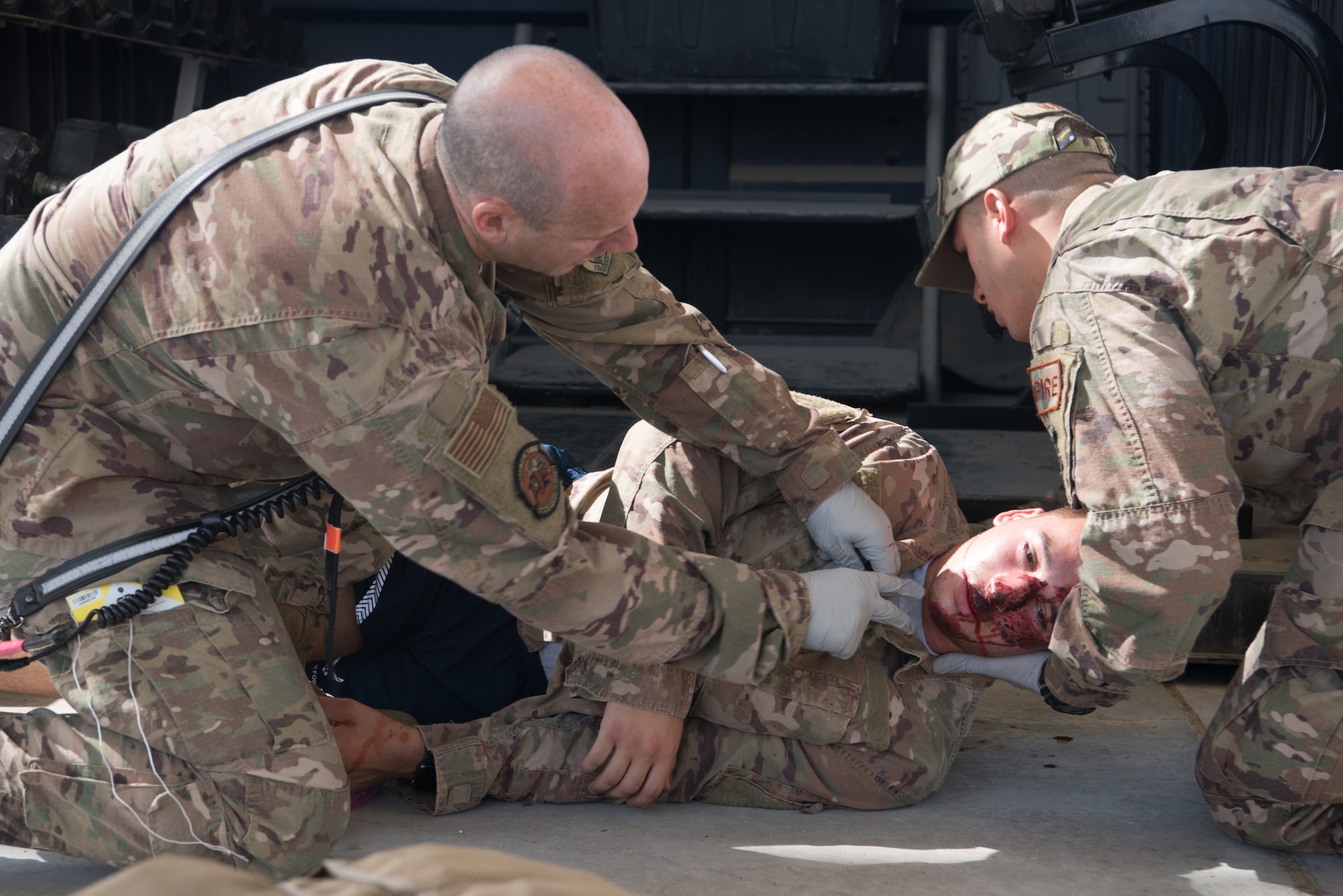 Firefighters assigned to the 380th Expeditionary Civil Engineer Squadron medically evaluate Senior Airman Naseem Eissa, 380th Expeditionary Logistics Readiness Squadron ground transportation operator, a moulage victim, during an exercise Sept. 24, 2019, on Al Dhafra Air Base, United Arab Emirates. A variety of agencies including medics, firefighters and security forces defenders participated in the exercise to test their readiness, knowledge of emergency procedures and interagency cooperation amongst the wing’s first responders. (U.S. Air Force photo by Tech. Sgt. Jocelyn A. Ford)