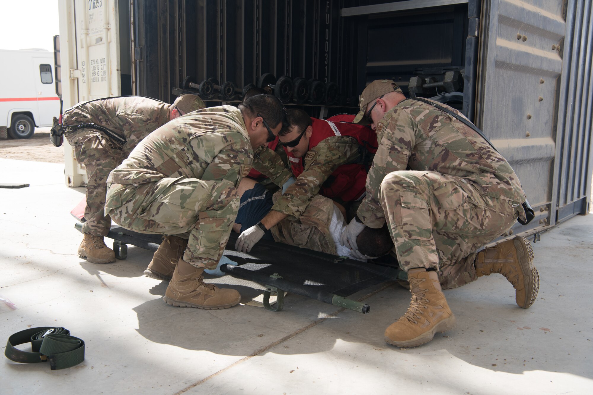 First responders work together to roll a simulated casualty onto a litter during a first responder exercise Sept. 24, 2019, on Al Dhafra Air Base, United Arab Emirates. A variety of agencies including medics, firefighters and security forces defenders participated in the exercise to test their readiness, knowledge of emergency procedures and interagency cooperation amongst the wing’s first responders. (U.S. Air Force photo by Tech. Sgt. Jocelyn A. Ford)
