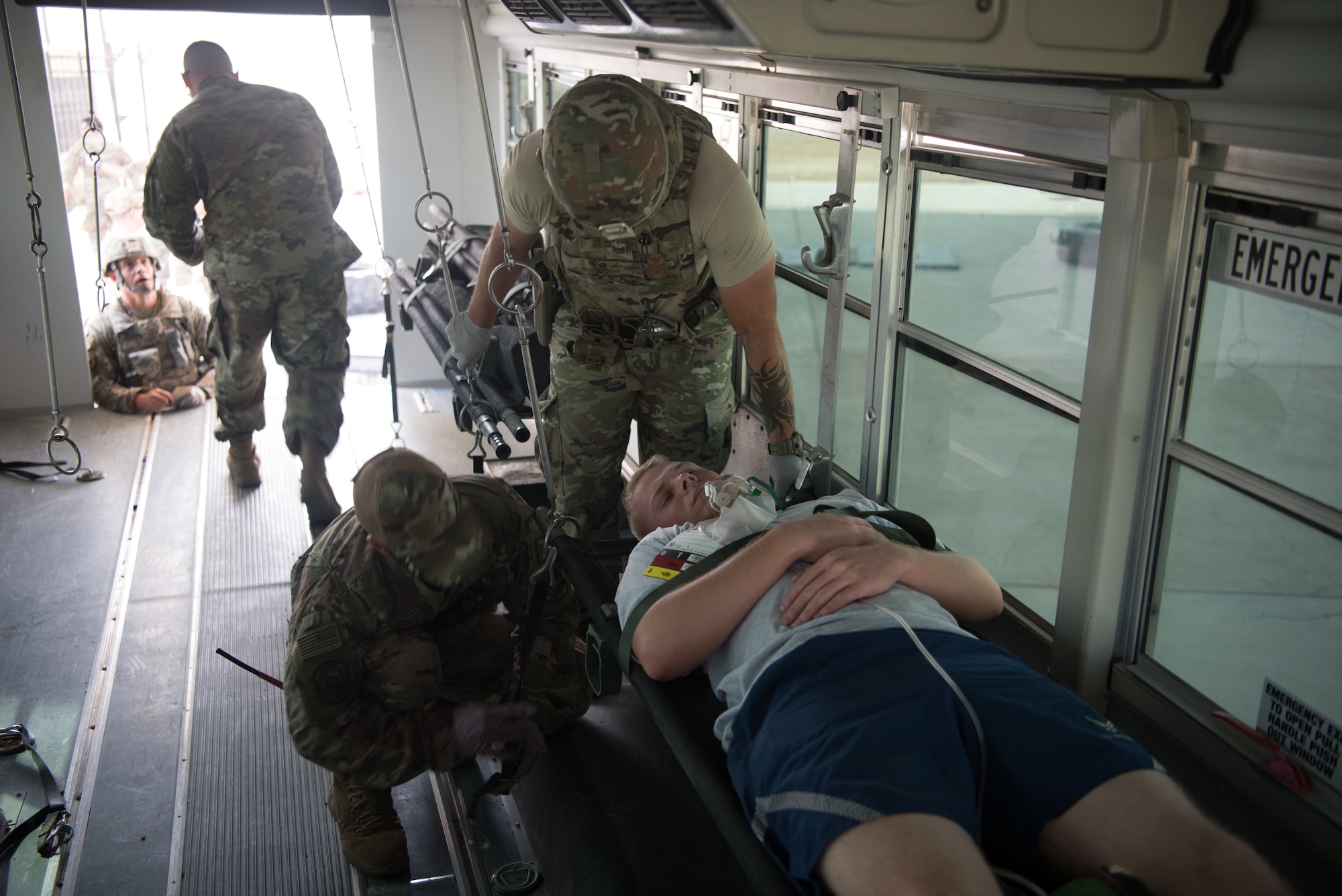 First responders secure a simulated casualty in a medical transportation bus during an exercise Sept. 24, 2019, on Al Dhafra Air Base, United Arab Emirates. The exercise showcased the readiness, knowledge of emergency procedures and interagency cooperation amongst the wing’s first responders. (U.S. Air Force photo by Tech. Sgt. Jocelyn A. Ford)