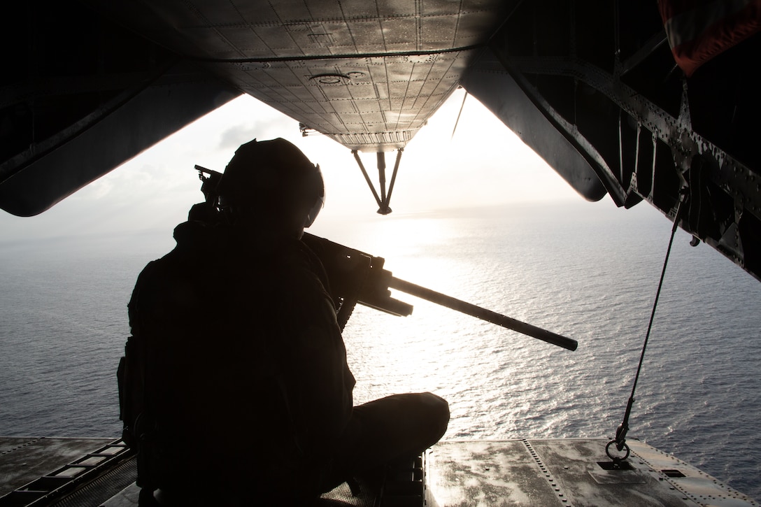 A U.S. Marine crew chief with the Special Purpose Marine Air-Ground Task Force - Southern Command mans the rear of a CH-53 during a refueling flight off the coast of Honduras, Aug. 13, 2019. The task force is conducting training and engineering projects hand-in-hand with partner nation military members in the region during their deployment that coincides with hurricane season.