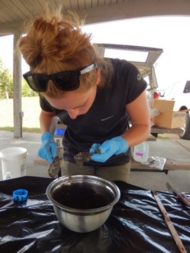 U.S. Army Corps of Engineers, Savannah District Geologist April Kelly consolidates a soil sample in preparation for shipment to the Environmental Materials Unit and Environmental Monitoring and Technologies, Inc., laboratories. The samples were collected as part of an Augusta Training Wall disposition study. USACE photo by Justin Nixon.