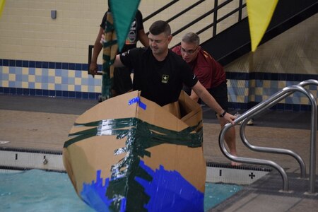 Battalion commander pushing-off to race to the other side of the pool during the  "Boat Wars" competition at Gammon Physical Fitness Center, Fort Knox, Kentucky, Sept. 22. The "Boat War" was a team building exercise that leadership teams participated in during the 3rd Recruiting Brigade's three-day training forum.