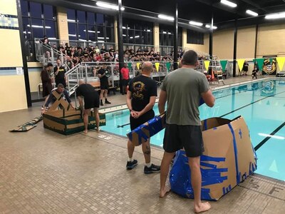 Battalion command teams prepare to launch their boats in the pool for the "Boat Wars" competition at Gammon Physical Fitness Center, Fort Knox, Kentucky, Sept. 22. The "Boat War" was a team building exercise that leadership teams participated in during the 3rd Recruiting Brigade's three-day training forum.