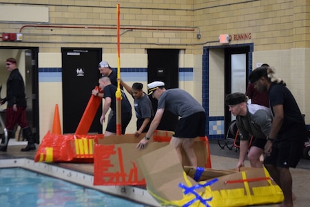 Battalion leadership teams prepare to put their boats in the pool for the "Boat Wars" competition at Gammon Physical Fitness Center here Sept. 22. The "Boat War" was a team building exercise that leadership teams participated in during the 3rd Recruiting Brigade's three-day training forum.