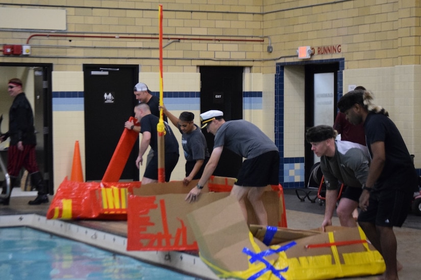 Battalion leadership teams prepare to put their boats in the pool for the "Boat Wars" competition at Gammon Physical Fitness Center here Sept. 22. The "Boat War" was a team building exercise that leadership teams participated in during the 3rd Recruiting Brigade's three-day training forum.