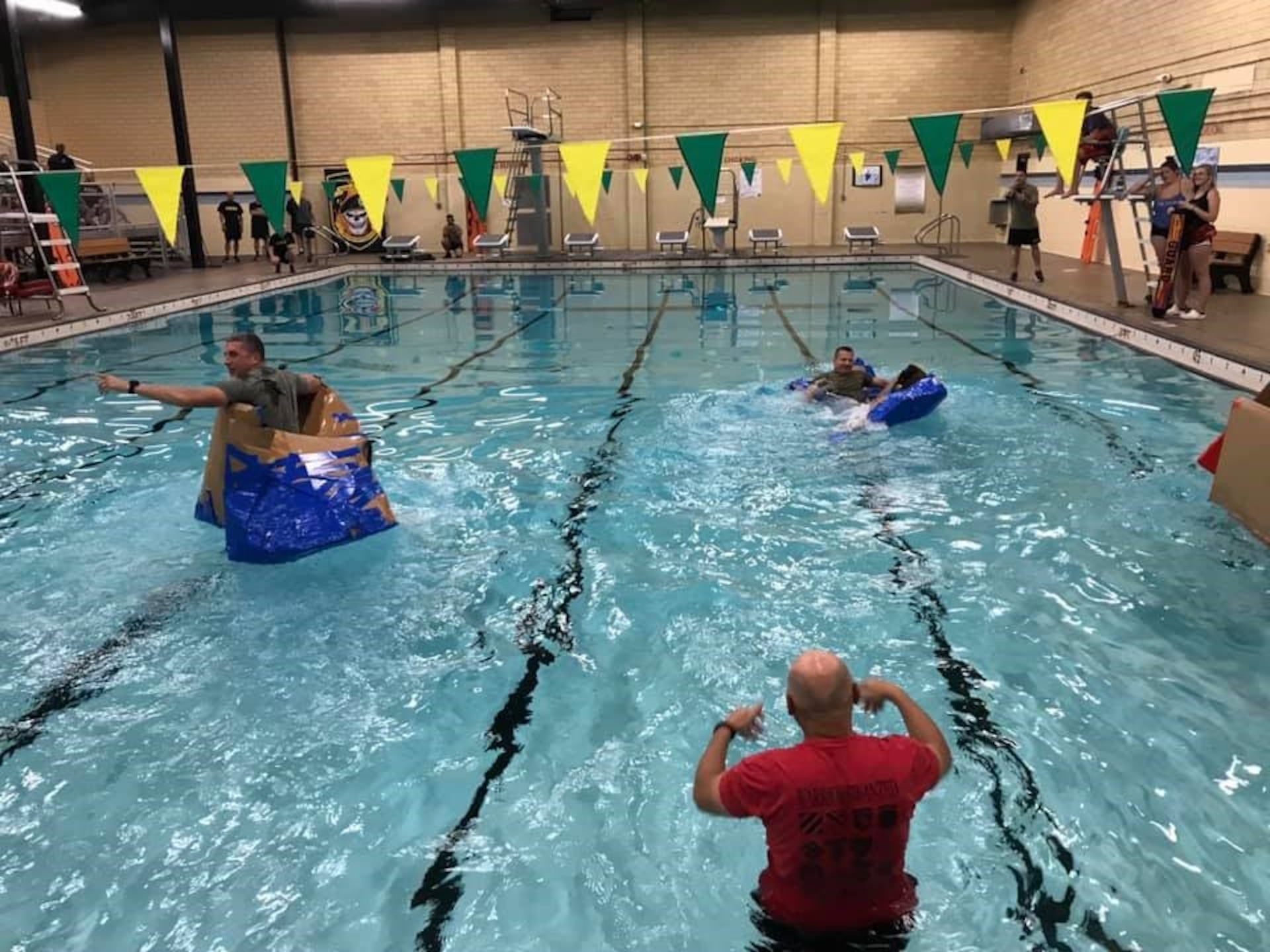 Battalion leadership teams racing to the finish line during the "Boat Wars" competition at Gammon Physical Fitness Center, Fort Knox, Kentucky, Sept. 23. The "Boat War" was a team building exercise that leadership teams participated in during the 3rd Recruiting Brigade's three-day training forum.