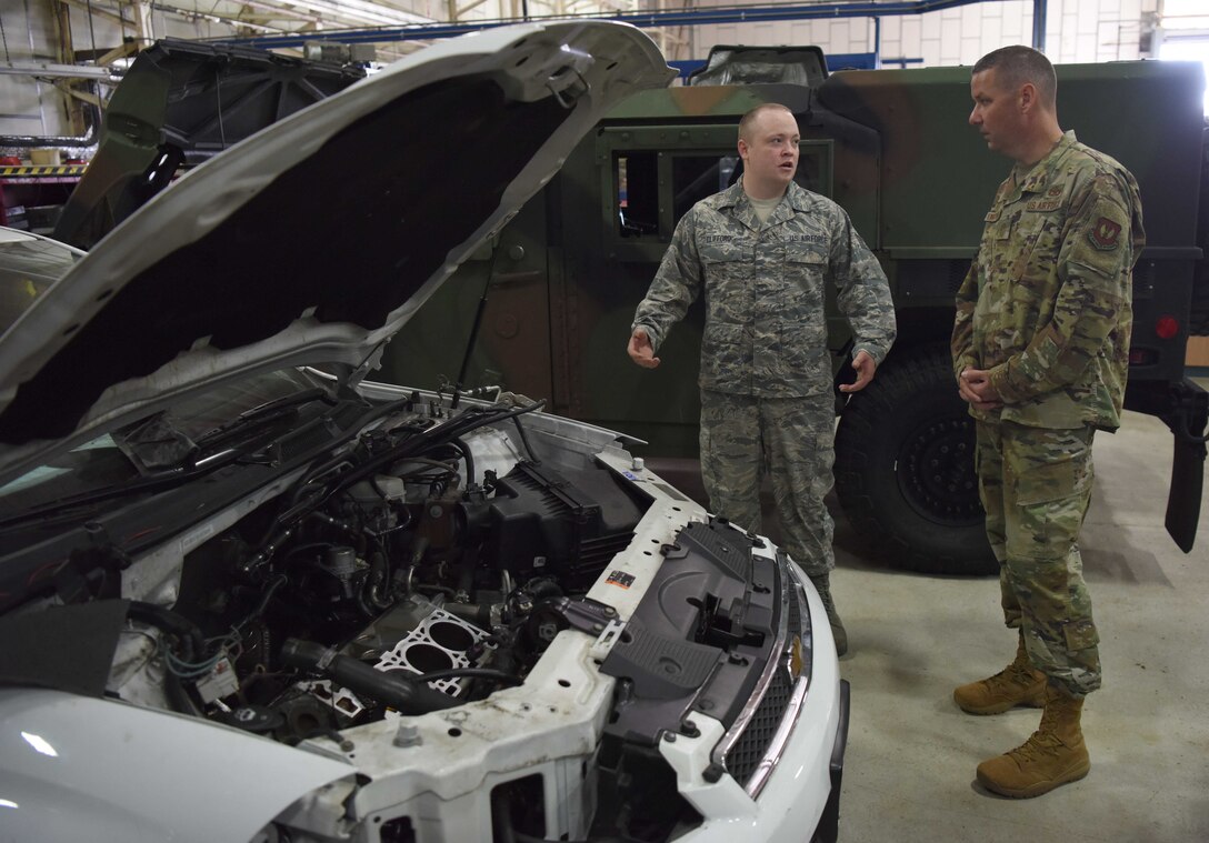 Chief Master Sgt. Randy Kwiatkowski, Third Air Force command chief, receives a briefing from Staff Sgt. Baile Clifford, 100th Logistics Readiness Squadron vehicle maintenance technician, during a visit to RAF Mildenhall, England, Sept. 13, 2019. During the visit, Kwiatkowski was exposed to the capabilities of the 100th Communication Squadron’s mission defense team, the 100th LRS vehicle maintenance operations as well as visiting with the 100th Force Support Squadron and their impact on Airmen and family readiness every day. (U.S. Air Force photo by Airman 1st Class Brandon Esau)