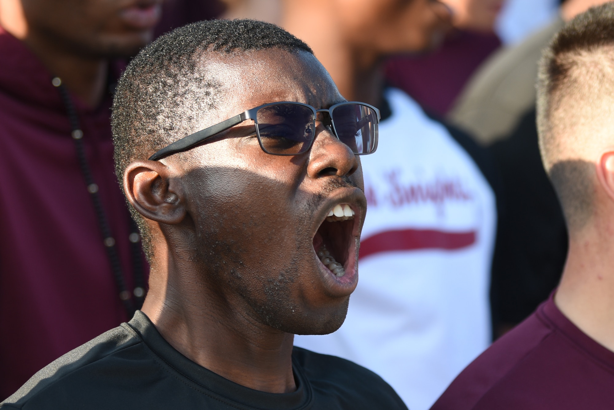An Airman from the 338th Training Squadron cheers on his squadron drill team during the 81st Training Group drill down on the Levitow Training Support Facility drill pad at Keesler Air Force Base, Mississippi, Sept. 20, 2019. Airmen from the 81st Training Group competed in a quarterly open ranks inspection, regulation drill routine and freestyle drill routine. While in training, Airmen are given the opportunity to volunteer to learn and execute drill down routines. (U.S. Air Force photo by Airman Seth Haddix)