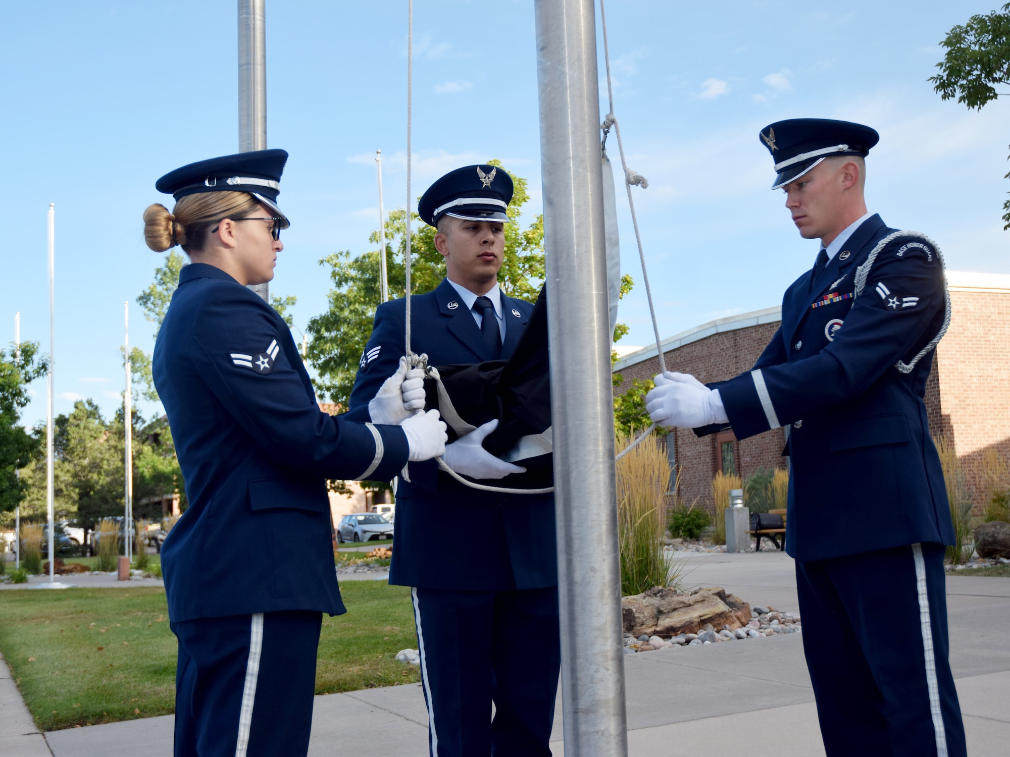 Members of the High Frontier Honor Guard mark the beginning of Prisoner of War/Missing in Action Remembrance Week by raising the POW/MIA flag during reveille on Peterson Air Force Base, Colorado, Sept. 16, 2019. The week was marked by events including a 24-hour remembrance run and a remembrance ceremony with guest speaker Mark L. Stephensen II, vice-chairman of the National League of POW/MIA Families. (U.S. Air Force photo by Griffin Swartzell)