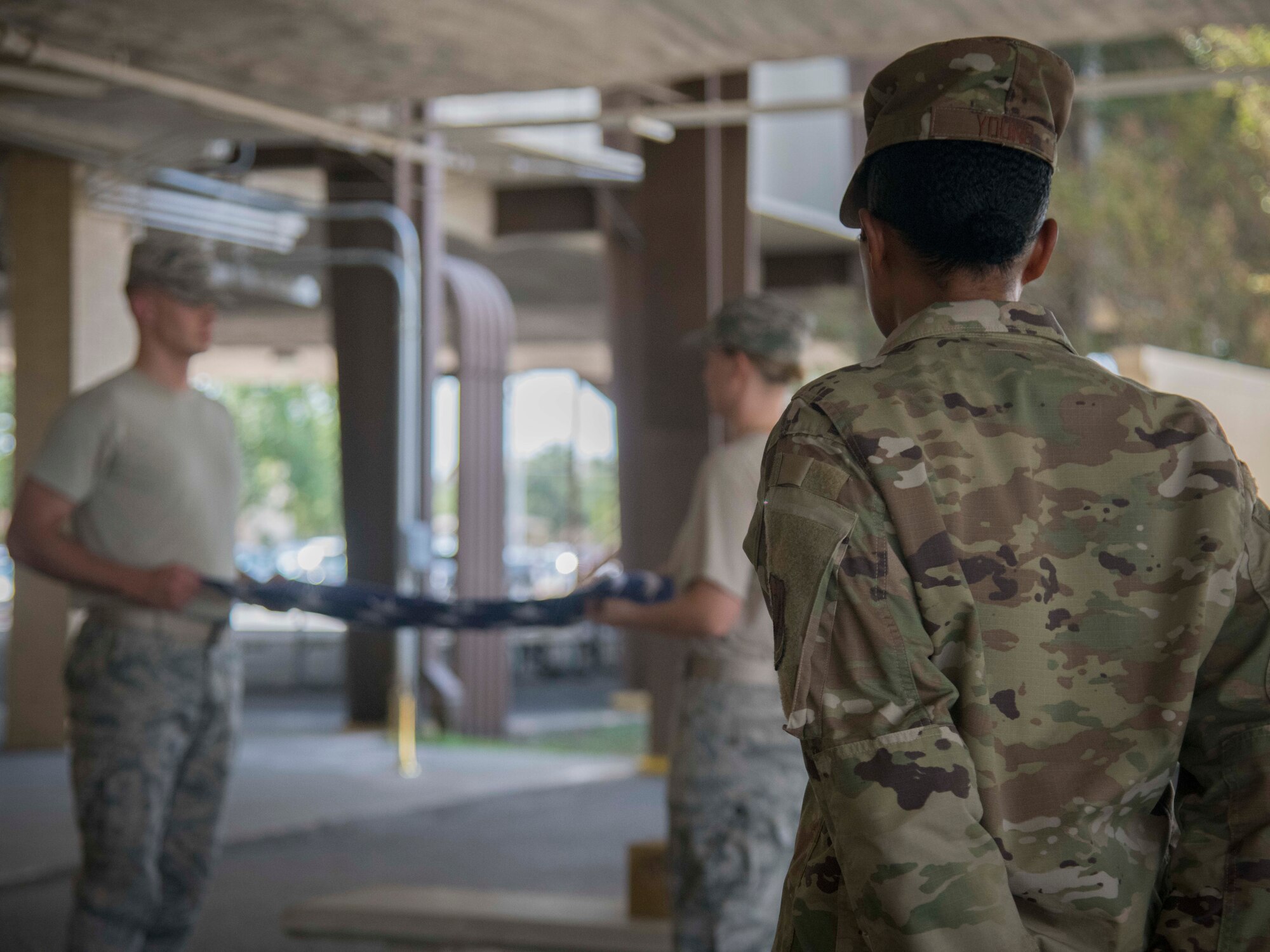 Airman First Class Jordyn Young, 35th Intelligence Squadron cyber threat analyst, trains two Joint Base San Antonio Honor Guard trainees Sept. 9, 2019 at the JBSA Honor Guard Squadron. JBSA Honor Guard trainers are guardsmen currently in honor guard duty who are chosen to teach others because of their exceptional performance in honor guard.
