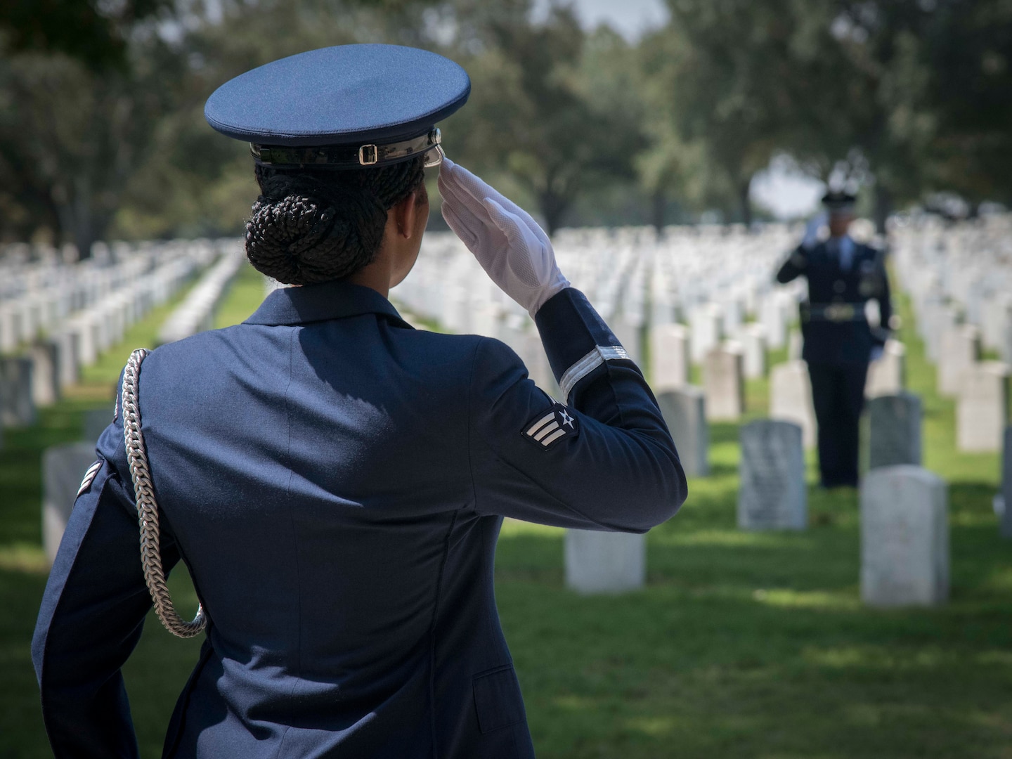 Senior Airman Chyna Roston, 559th Medical Squadron mental health technician, salutes another Joint Base Honor Guardsman while practicing for a funeral service Sept. 9, 2019 at the Fort Sam Houston National Cemetery. Before each service performed by JBSA Honor Guard, the detail arrives early to practice the service to ensure perfection before performing in front of the family. (U.S. Air Force photo by: Airman 1st Class Shelby Pruitt)