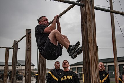 Soldiers with Michigan National Guard's 46 Military Police Command conduct the leg tuck event during the Army Combat Fitness Test September 2019 at Joint Force Headquarters in Lansing, Mich.