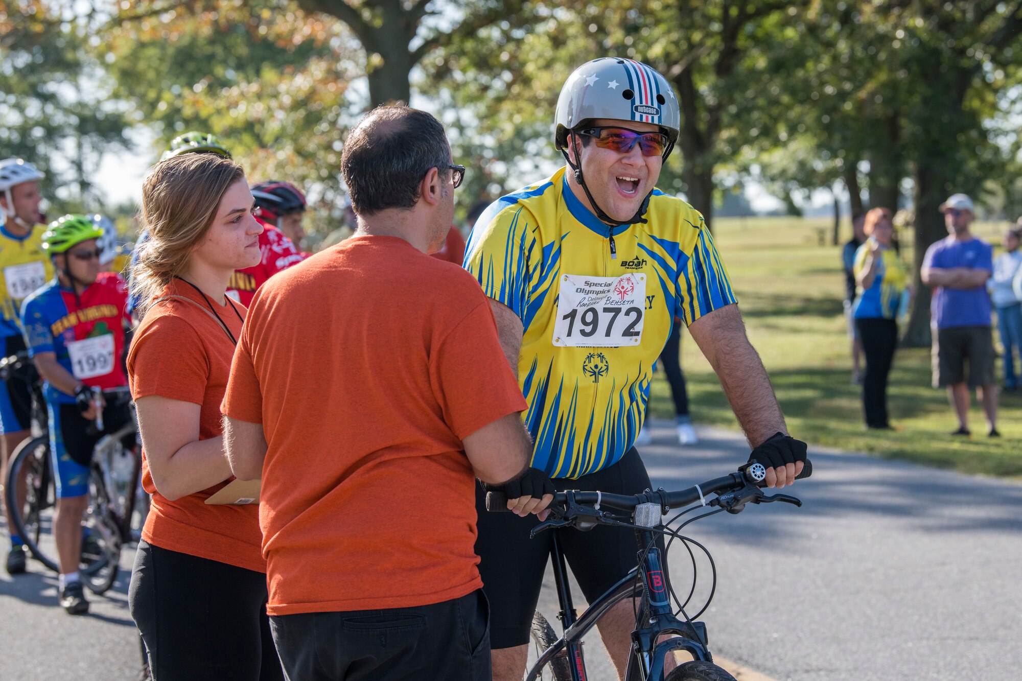 Roozhan Behseta, a contestant, smiles as he is told the rules of the race during the Special Olympics Delaware 2019 cycling tournament Sept. 21, 2019, at Dover Air Force Base, Del. The event featured different races, including a 500m, a 1K, a 5K, a 10K, 15K and a 20K. (U.S. Air Force photo by Senior Airman Christopher Quail)