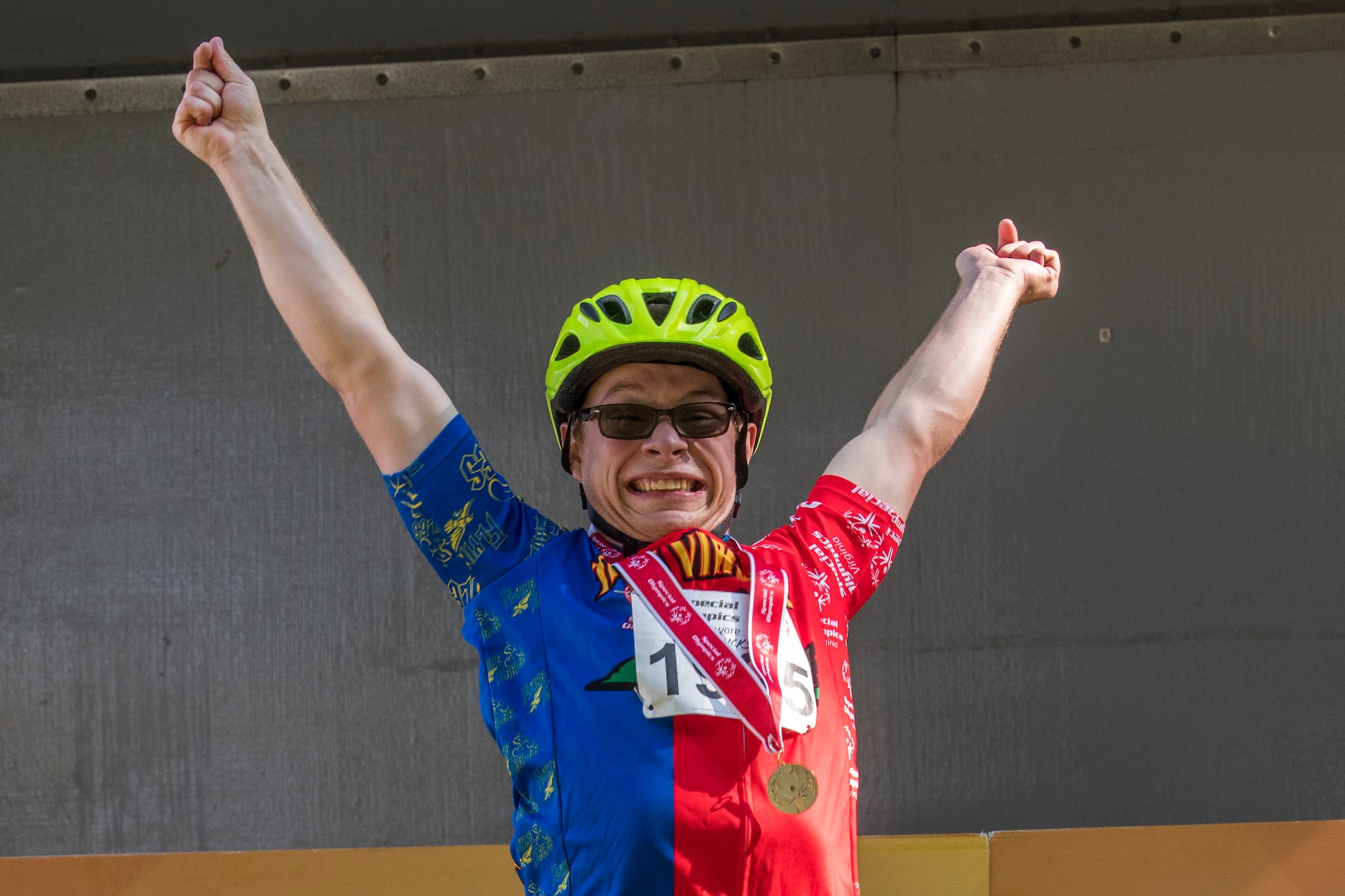 Will Dickson, a contestant, raises his hands up high after receiving a gold medal during the Special Olympics 2019 cycling tournament Sept. 21, 2019, at Dover Air Force Base, Del. The contestants were awarded medals after each race, based on their divisions. (U.S. Air Force photo by Senior Airman Christopher Quail)