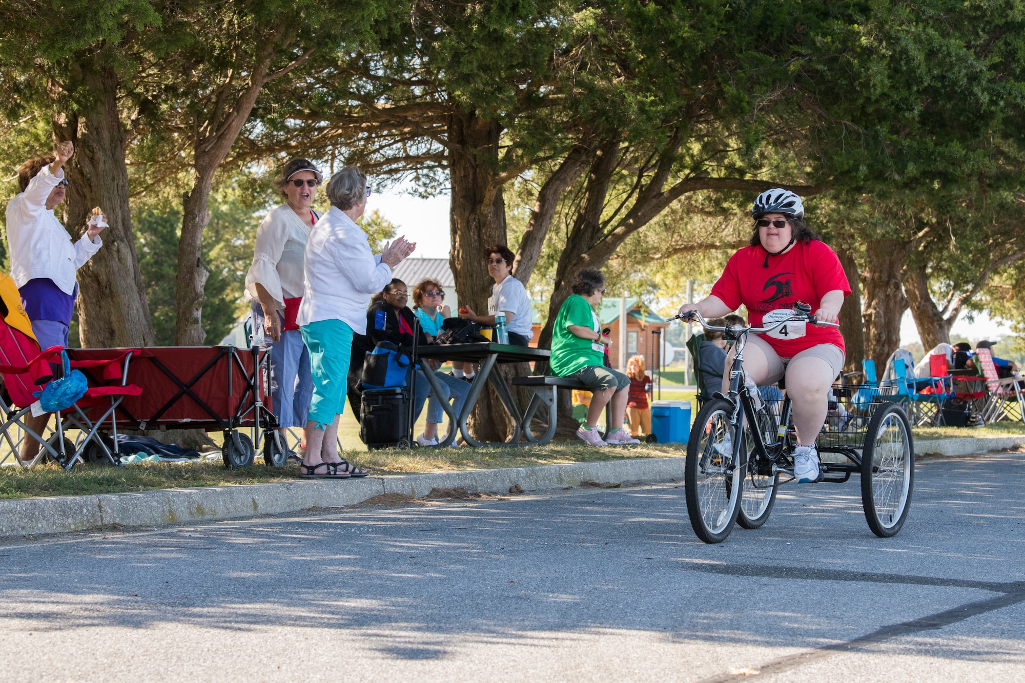 Wendi Revels, a contestant, races as the crowd cheers her on during the Special Olympics Delaware 2019 cycling tournament Sept. 21, 2019, at Dover Air Force Base, Del. Several teams attended the event from Delaware, Maryland, Virginia and Florida. (U.S. Air Force photo by Senior Airman Christopher Quail)