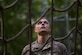 U.S. Army Pvt. Jeffrey Lawless, Charlie Company, 222nd Battalion, 1st Aviation Regiment, 128th Aviation Brigade UH-60 Black Hawk helicopter advanced individual training student, looks up at a cargo net during a field training exercise at Joint Base Langley-Eustis, Virginia, Sept. 18, 2019.