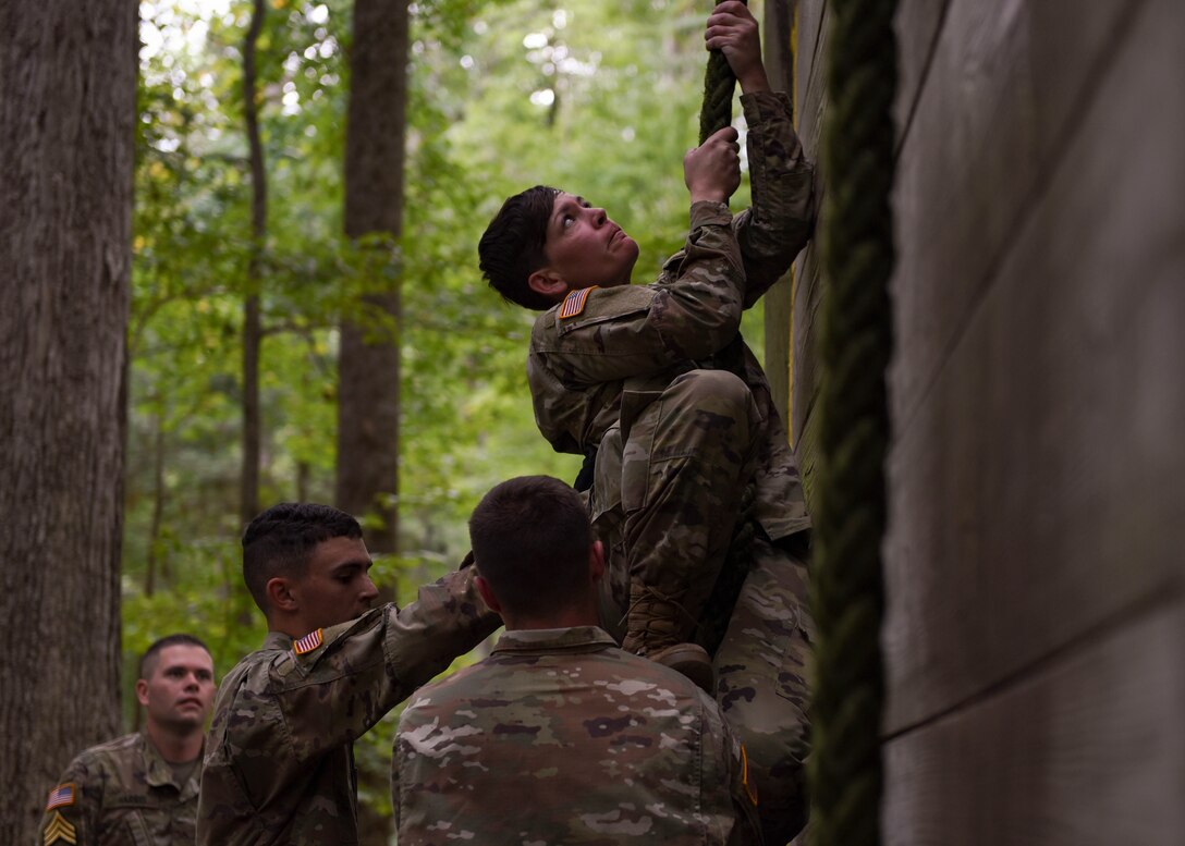 U.S. Army initial entry training Soldiers help a teammate climb a wall during a field training exercise at Joint Base Langley-Eustis, Virginia, Sept. 18, 2019.