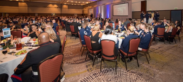 Attendees of the Joint Base Charleston Air Force Ball raise their glasses in honor of the prisoners of war and the individuals who went missing in action, Sep. 14, 2019, in Charleston, S.C.