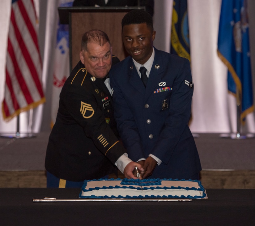 Retired Army Staff Sgt. Dan Powers, a former squad leader with the 118th military police company, and Airman 1st Class Deon Stevenson, a firefighter from the 628th Civil Engineer Squadron, cut the cake at the Joint Base Charleston Air Force ball, Sep. 14, 2019, in Charleston, S.C.