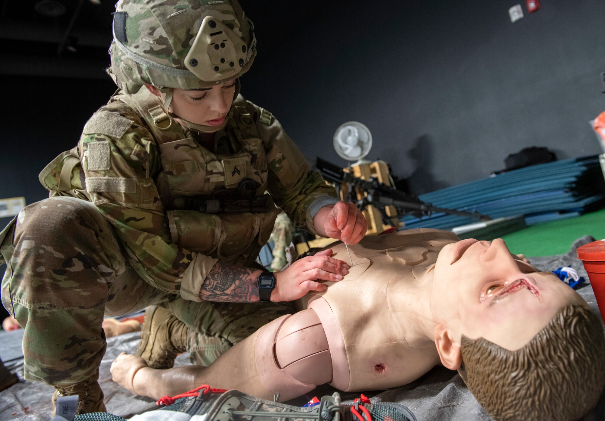 Army Cpl. Katelynne Pace, a combat medic specialist assigned to Headquarters and Headquarters Company, 1st Battalion, 501st Parachute Infantry Regiment, 4th Infantry Brigade Combat Team (Airborne), 25th Infantry Regiment, U.S. Army Alaska, performs a needle decompression on a simulated combat casualty during annual recertification at Joint Base Elmendorf-Richardson, Alaska, Sept. 17, 2019. The medics utilized the Tactical Combat Casualty Care Exportable (TC3X) kit to maintain their skills and proficiency. The TC3X is a state of the art mannequin that mimics various traumatic scenarios, simulates human pulmonary and respiratory functions/distress, and augments realistic training by screaming, breathing, bleeding, moving, physiologically responding to treatments rendered and providing feedback data via recording sensors. Pace is a native of Brevard, N.C. (U.S. Air Force photo by Alejandro Peña)