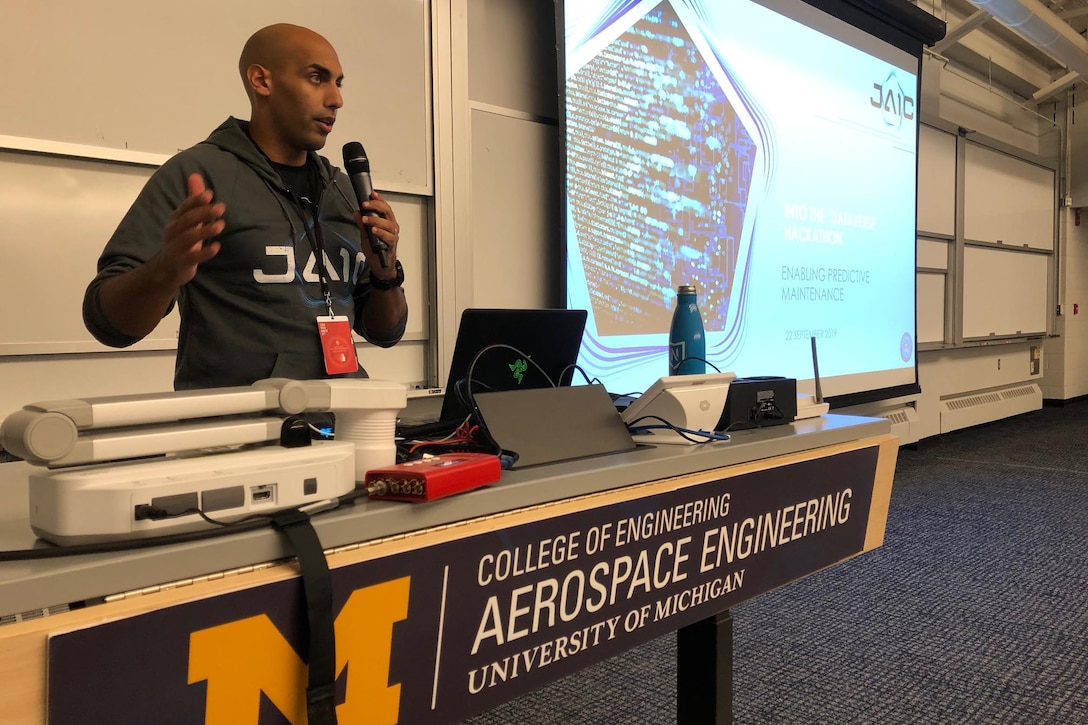 Marine Corps Maj. Dan Tadross, a mentor from the Joint Artificial Intelligence Center, speaks to hackers working on artificial intelligence solutions for aircraft maintenance at the National Security Innovation Network “Into the Dataverse” Hackathon. The event was held at the University of Michigan’s School of Aerospace Engineering in Ann Arbor, Mich., Sept. 21, 2019.