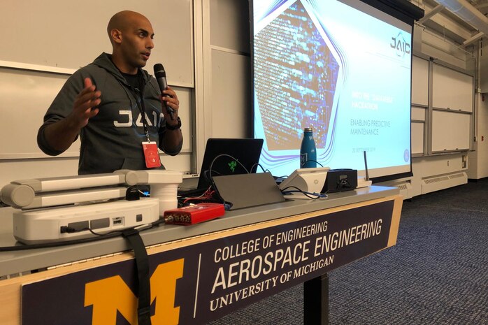 Marine Corps Maj. Dan Tadross, a mentor from the Joint Artificial Intelligence Center, speaks to hackers working on artificial intelligence solutions for aircraft maintenance at the National Security Innovation Network “Into the Dataverse” Hackathon. The event was held at the University of Michigan’s School of Aerospace Engineering in Ann Arbor, Mich., Sept. 21, 2019.