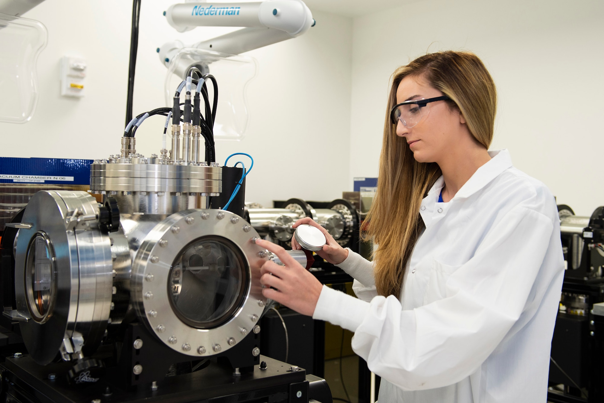 Victoria Scira, a nuclear data analyst at the Air Force Technical Applications Center, Patrick AFB, Fla., examines a thermal ionization mass spectrometer in the AFTAC's Ciambrone Radiochemistry Lab.  Scira was recently hired to work at the nuclear treaty monitoring center after being selected for the Air Force Personnel Center's Science and Engineering Palace Acquire program that offers permanent full-time positions in various career fields to prospective candidates (U.S. Air Force photo by Matthew S. Jurgens)