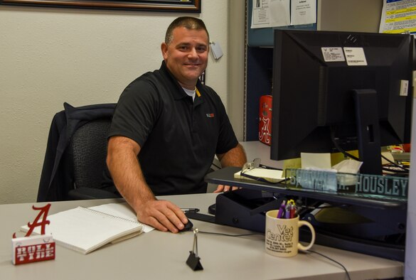 Shawn Housley poses at his desk.