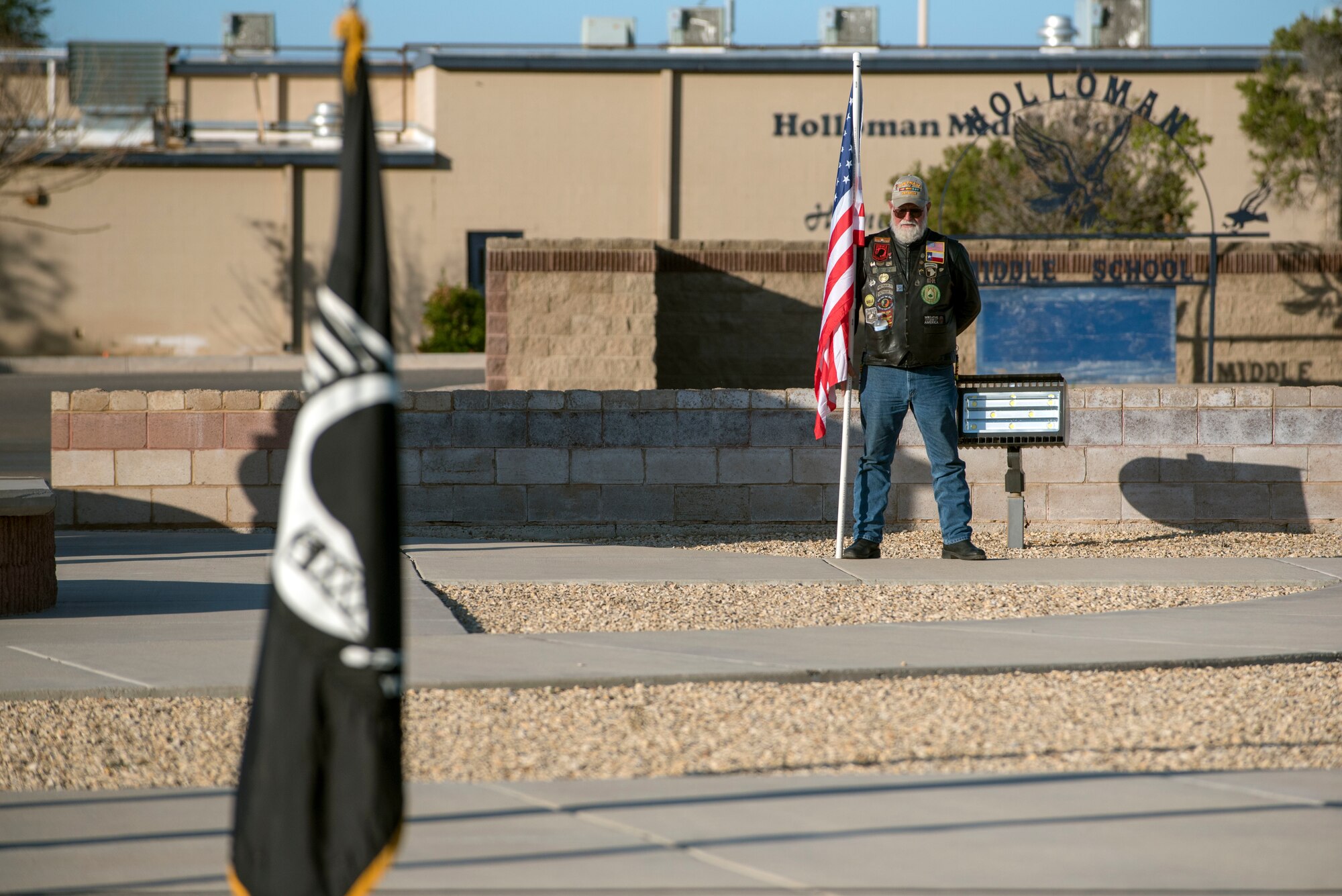 A local Alamogorodo veteran from the Patriot Guard Riding Club stands with a U.S. flag during a POW/MIA Remembrance Ceremony on Holloman Air Force Base, N.M., Sept. 20, 2019. The Patriot Guard Riding Club is a motorcycle group whose mission is to attend funeral services of fallen military personnel. (U.S. Air Force photo by Staff Sgt. Christine Groening)