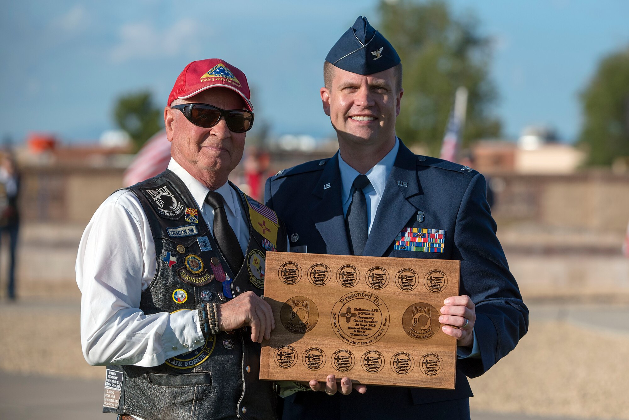 Deacon Jim Ernst, Patriot Guard Riders New Mexico State captain, receives a plaque from Col. John Davis, 49th Medical Group commander, during a POW/MIA Remembrance Ceremony on Holloman Air Force Base, N.M., Sept. 20, 2019. There are currently 12 unaccounted for New Mexican prisoners of war and missing in action military members. (U.S. Air Force photo by Staff Sgt. Christine Groening)