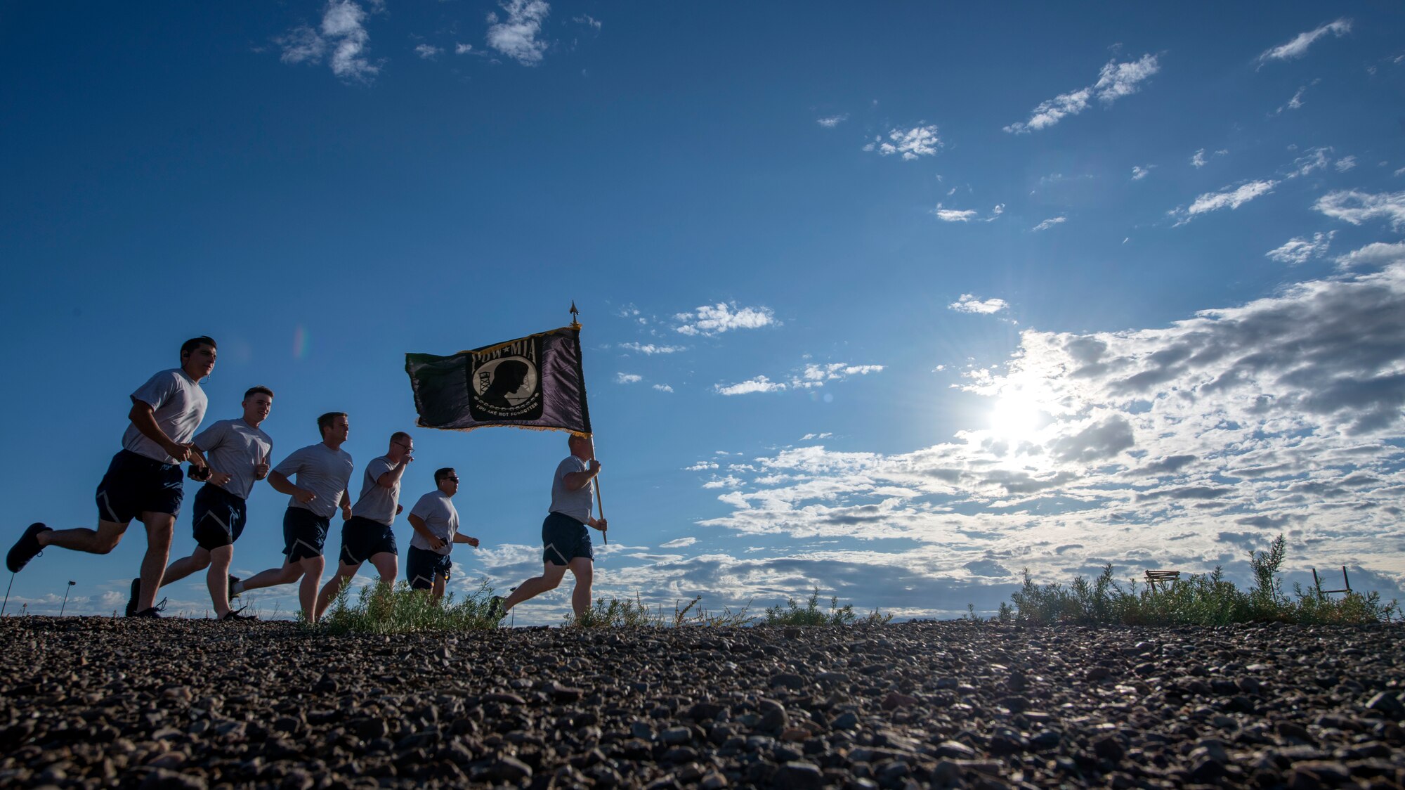 Airmen from the 635th Material Maintenance Group, run in remembrance of those who were imprisoned, on Holloman Air Force Base, N.M., Sept. 19, 2019. Every 30 minutes, Airmen rotated teams in order to keep the POW/MIA flag in motion. (U.S. Air Force photo by Staff Sgt. Christine Groening)
