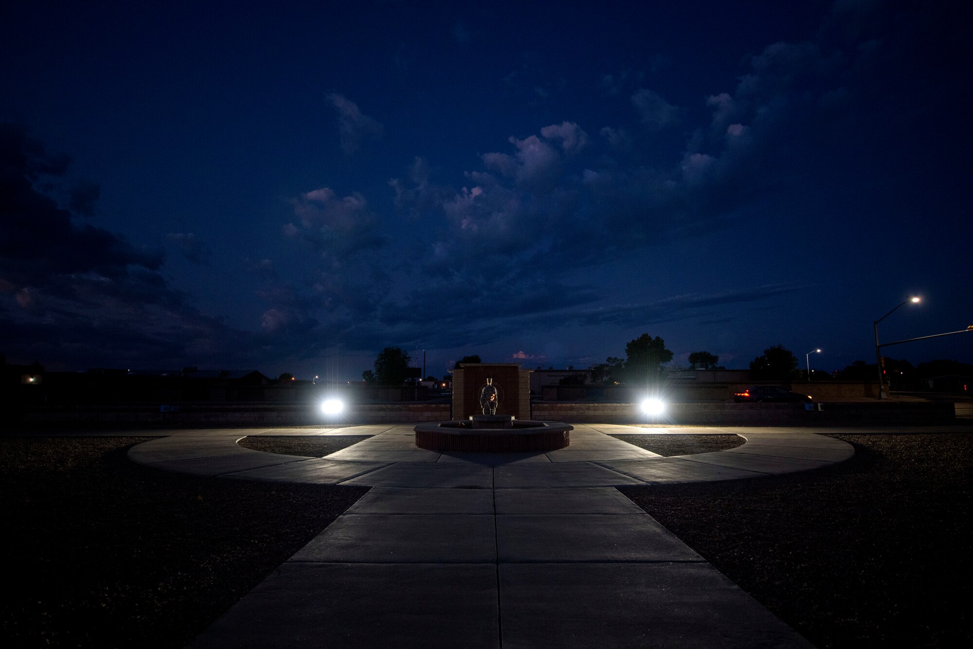 An Airman stands at attention in front of the POW/MIA Memorial at Heritage Park on Holloman Air Force Base, N.M., Sept. 20, 2019. During the 24-hour vigil, Airmen took turns standing at the memorial, honoring service members who were imprisoned and remain missing-in-action. (U.S. Air Force photo by Staff Sgt. Christine Groening)