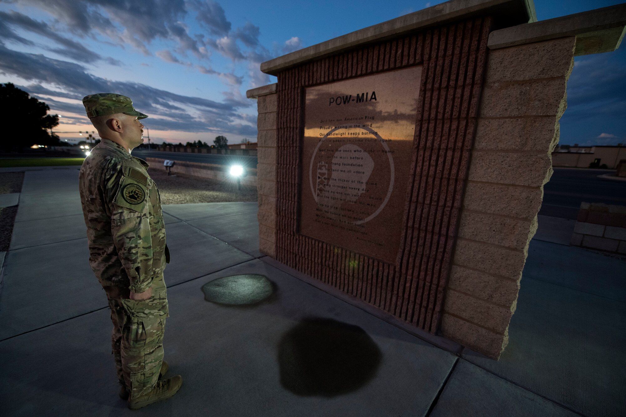 An Airman stands at attention in front of the POW/MIA Memorial at Heritage Park on Holloman Air Force Base, N.M., Sept. 20, 2019. During the 24-hour vigil, Airmen took turns standing at the memorial, honoring service members who were imprisoned and remain missing-in-action. (U.S. Air Force photo by Staff Sgt. Christine Groening)