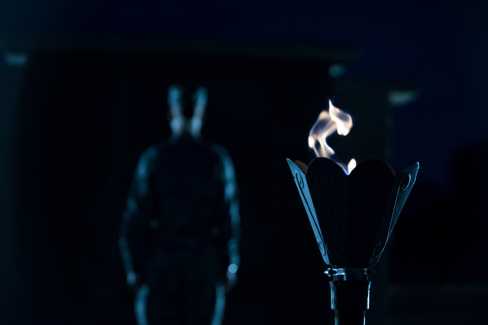 An Airman stands at attention in front of the POW/MIA Memorial at Heritage Park on Holloman Air Force Base, N.M., Sept. 20, 2019. During the 24-hour vigil, Airmen took turns standing at the memorial, honoring service members who were imprisoned and remain missing-in-action. (U.S. Air Force photo by Staff Sgt. Christine Groening)