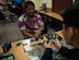 People play Yu-Gi-Oh cards at a gaming club tournament at Joint Base Langley-Eustis, Virgin ia, September 18, 2019. The tournaments provide U.S. Air Force Airmen, Soldiers, civilians and their families the opportunity to play games with other game enthusiasts. (U.S. Air Force photo by Airman 1st Class Sarah Dowe)
