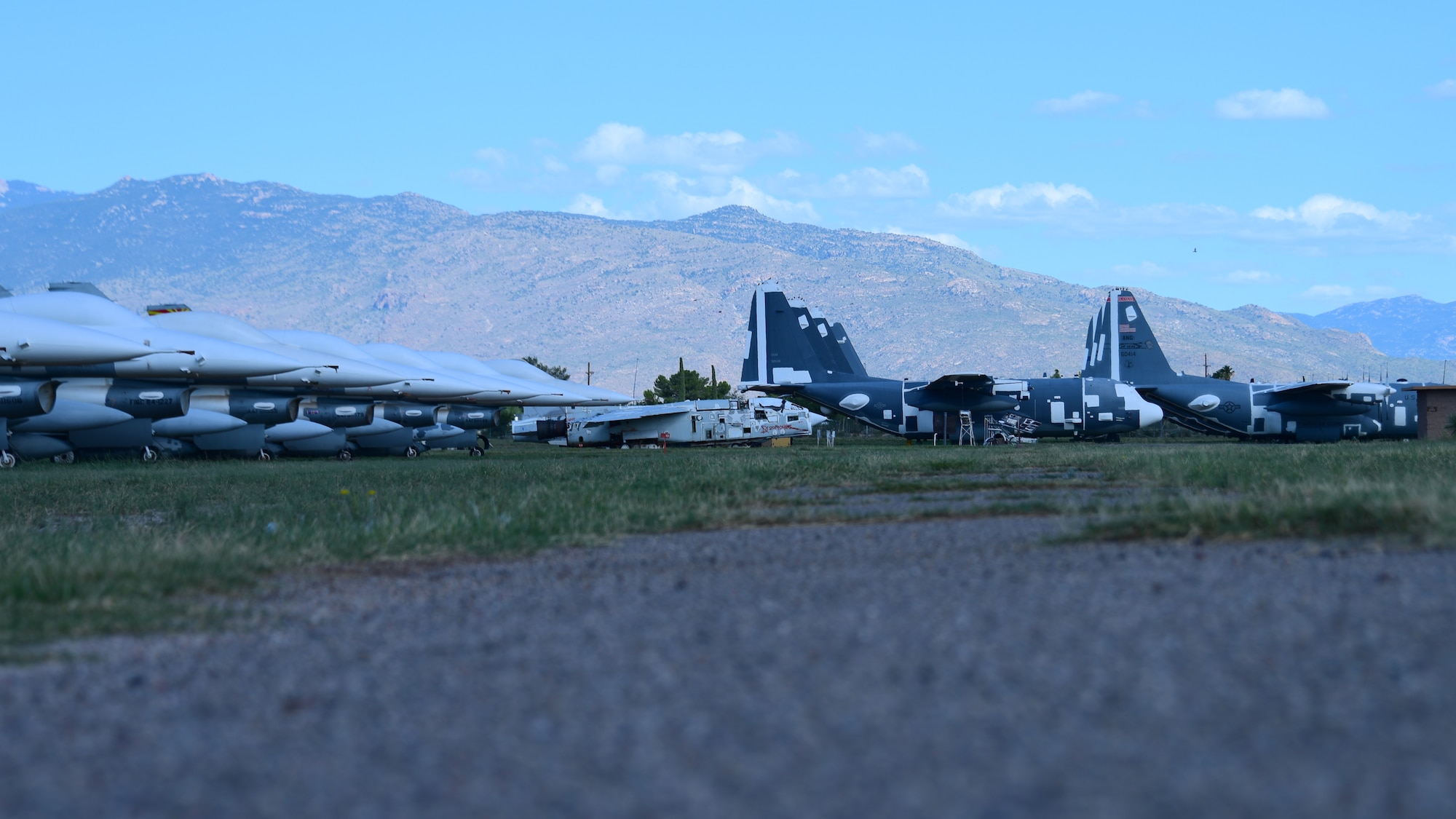 U.S. Air Force F-16 Fighting Falcons and C-130 Hercules sit in the 309th Aircraft Maintenance and Regeneration Group at Davis-Monthan Air Force Base, Arizona, Sept. 20, 2019. The AMARG houses aircraft from across the Department of Defense and other government agencies including NASA. (U.S. Air Force photo by Airman 1st Class Jacob T. Stephens)