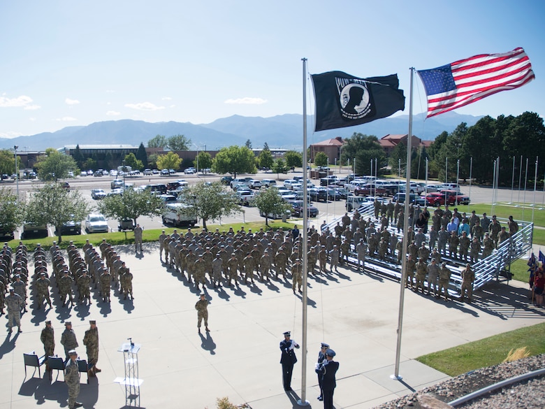 The High Frontier Honor Guard prepares to lower the Prisoner of War/Missing in Action flag Sept. 20, 2019, at Peterson Air Force Base, Colorado, during a retreat ceremony at the end of POW/MIA Remembrance Week. The week honors American service members who were captured overseas and all unreturned veterans. (U.S. Air Force photo by Griffin Swartzell)