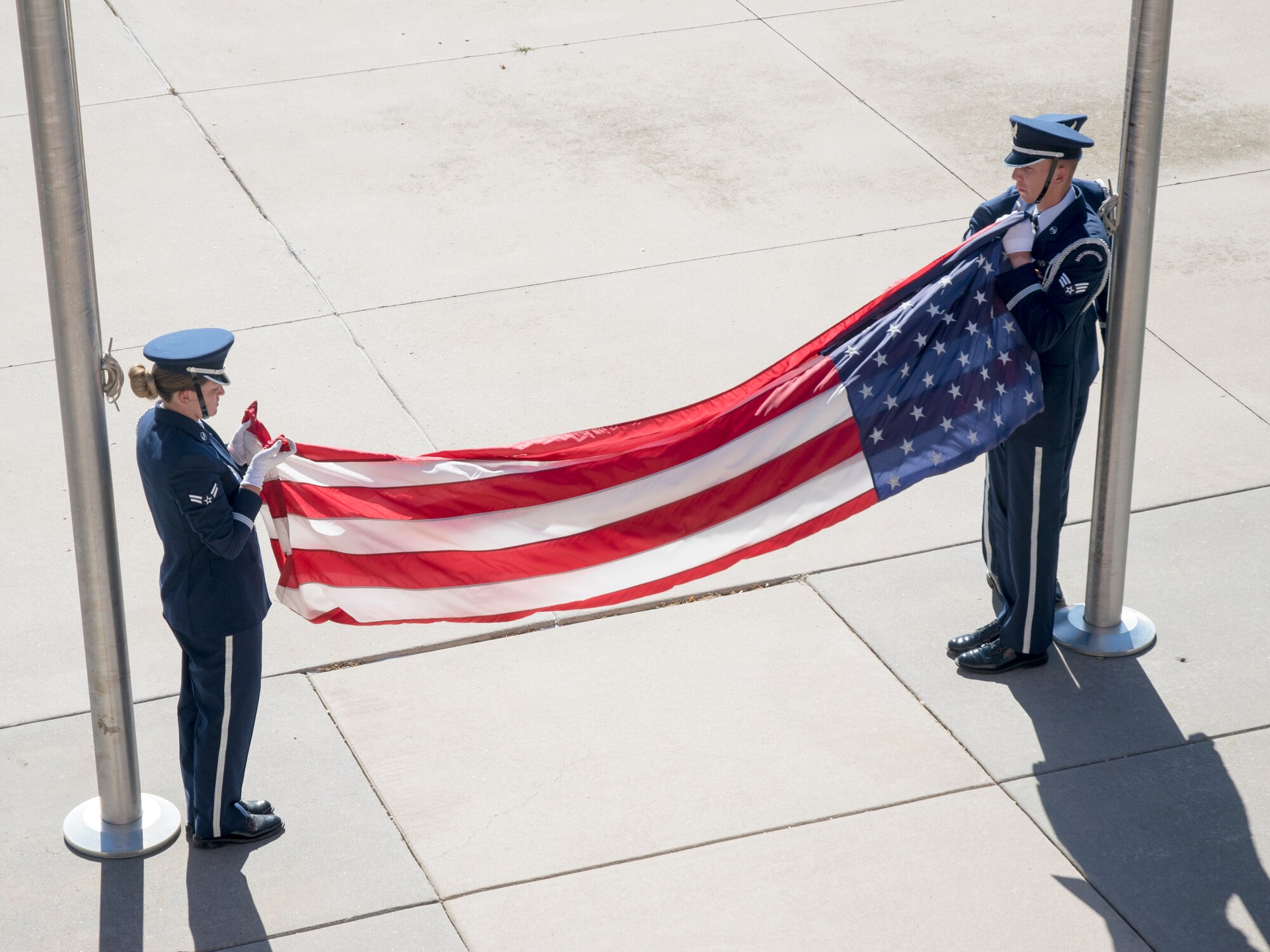 The High Frontier Honor Guard folds the U.S. flag for storage Sept. 20, 2019, at Peterson Air Force Base, Colorado, during a retreat ceremony at the end of POW/MIA Remembrance Week. The week honors those American service members who were captured overseas and all unreturned veterans. (U.S. Air Force photo by Griffin Swartzell)