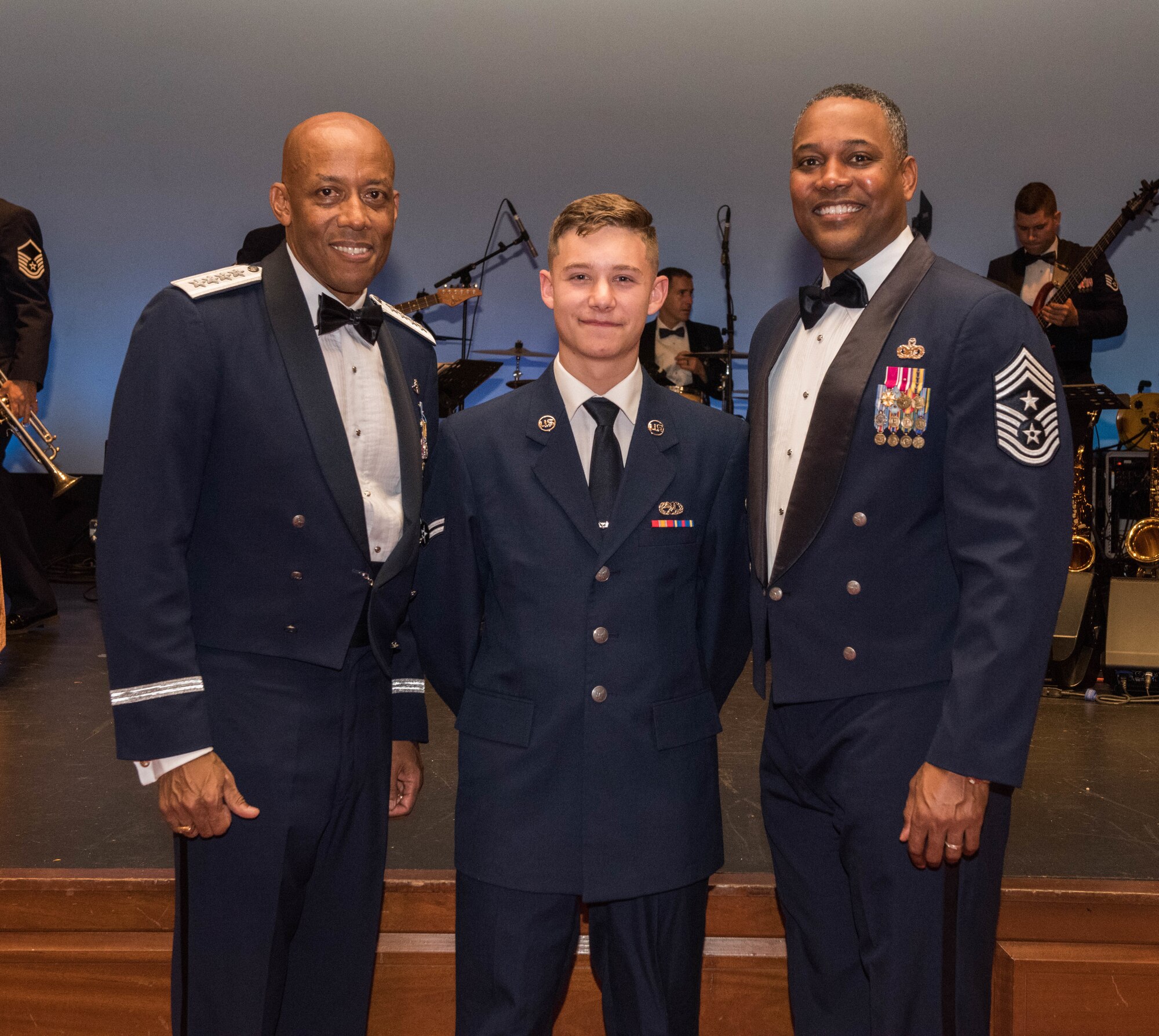 Gen. CQ Brown, Jr., Pacific Air Forces commander, and Chief Master Sgt. Anthony Johnson, PACAF command chief, take a photo with Airman 1st Class Treye Plants, the most junior Air Force member in attendance of the Air Force ball, Honolulu, Hawaii, Sept. 20, 2019. This year, the United States Air Force celebrated its 72nd birthday and Pacific Air Forces celebrated its 75th anniversary. As part of the birthday and anniversary celebrations, six former PACAF commanders and command chiefs visited Hawaii and were guests of honor. (U.S. Air Force photo by Staff Sgt. Hailey Haux)