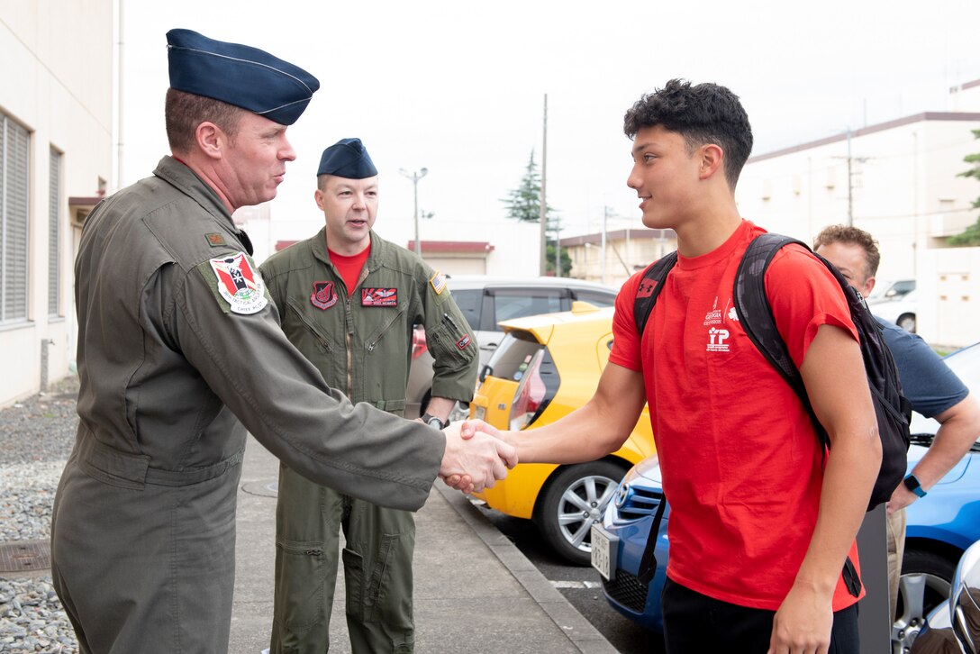 Maj. Frank Zientek, 36th Airlift Squadron chief pilot, greets Joey DeGrella, Yokota High School senior and Junior Reserve Officer Training Corps. class commander, prior to making DeGrella an honorary the Pilot for a Day, Sept. 20, 2019, at Yokota Air Base, Japan