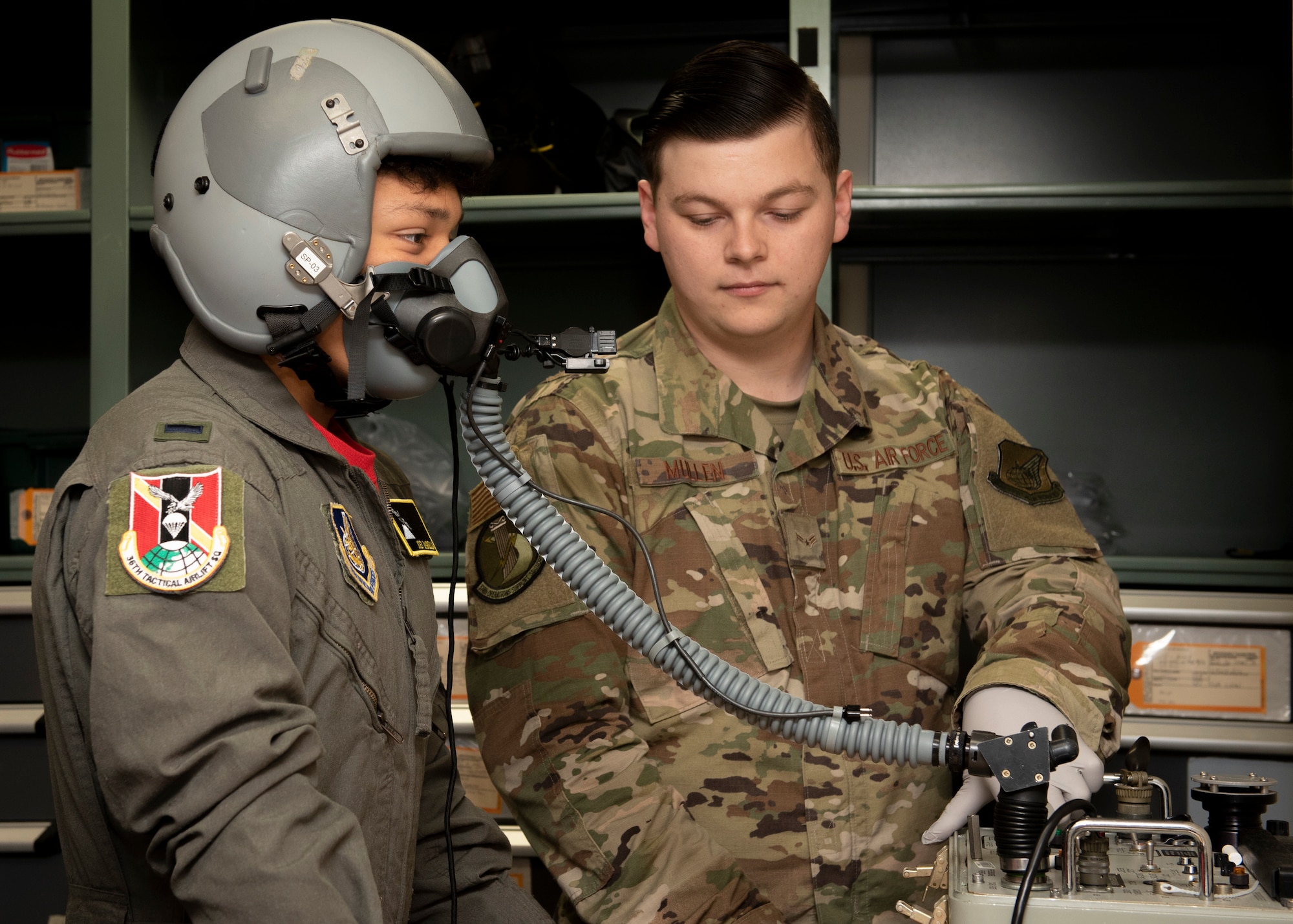 Joey DeGrella, 36th Airlift Squadron pilot for a day program participant, tries on an oxygen mask in the aircrew flight equipment office at Yokota Air Base, Japan, Sept. 20, 2019