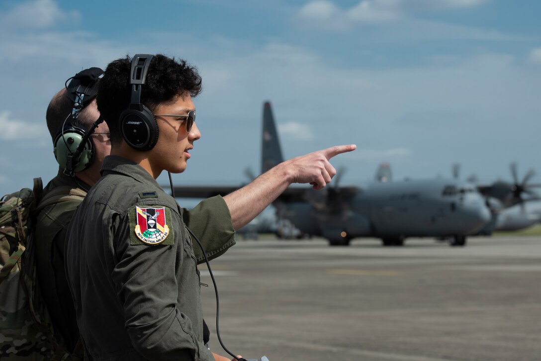 Joey DeGrella, Yokota High School senior and Junior Reserve Officer Training Corps. class commander, watches from afar as the pre-flight checklist is completed for the C-130J Super Hercules that he will fly on as part of the 36th Airlift Squadron’s Pilot for a Day program, Sept. 20, 2019, at Yokota Air Base, Japan.